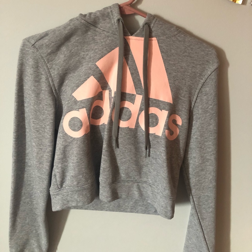 a grey and pink cropped adidas sweatshirt